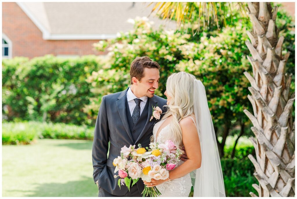 bride and groom smiling during first look at Wilmington wedding venue