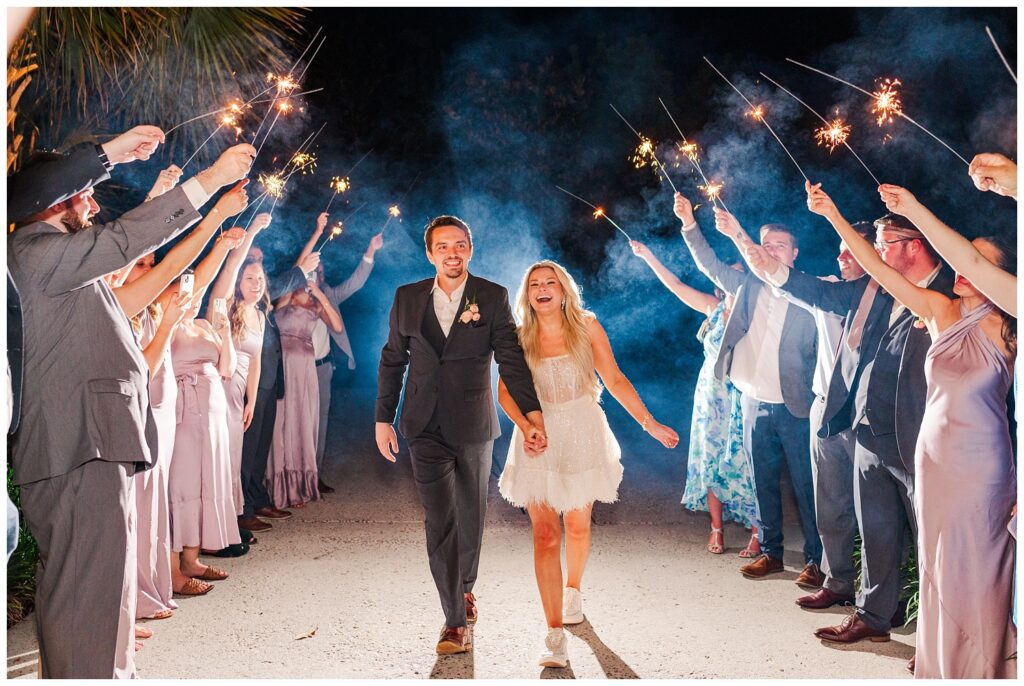 bride and groom walking through a line of wedding sparklers for reception exit