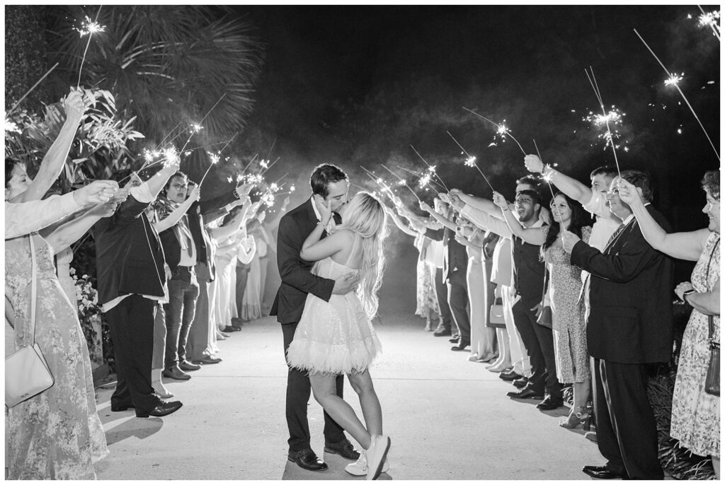 bride and groom walking through a line of wedding sparklers for reception exit