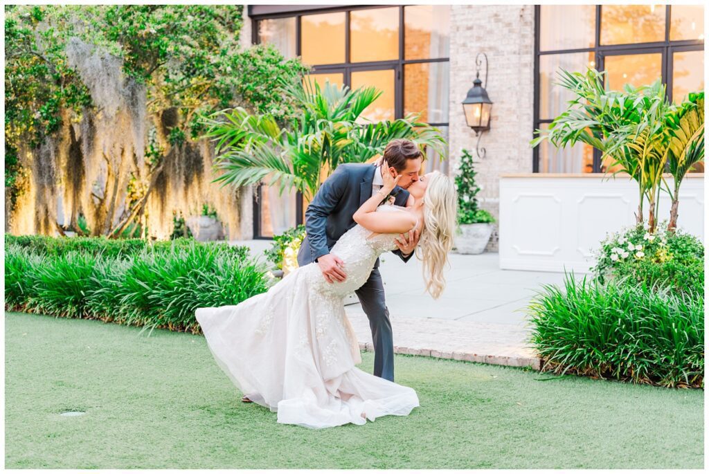 groom dipping back the bride for a kiss during golden hour in Wilmington