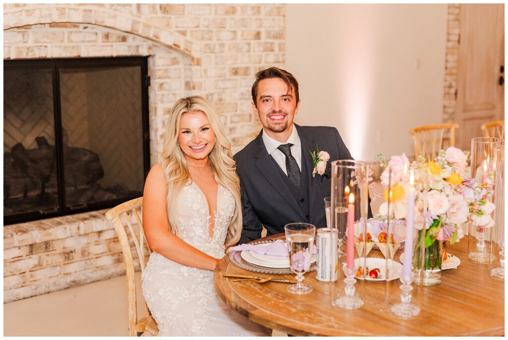 bride and groom seated together at the sweetheart table at Wrightsville Manor