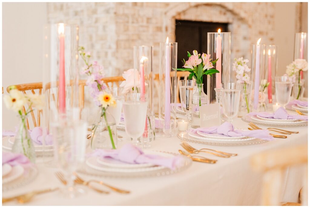 reception table with purple napkins and gold cutlery