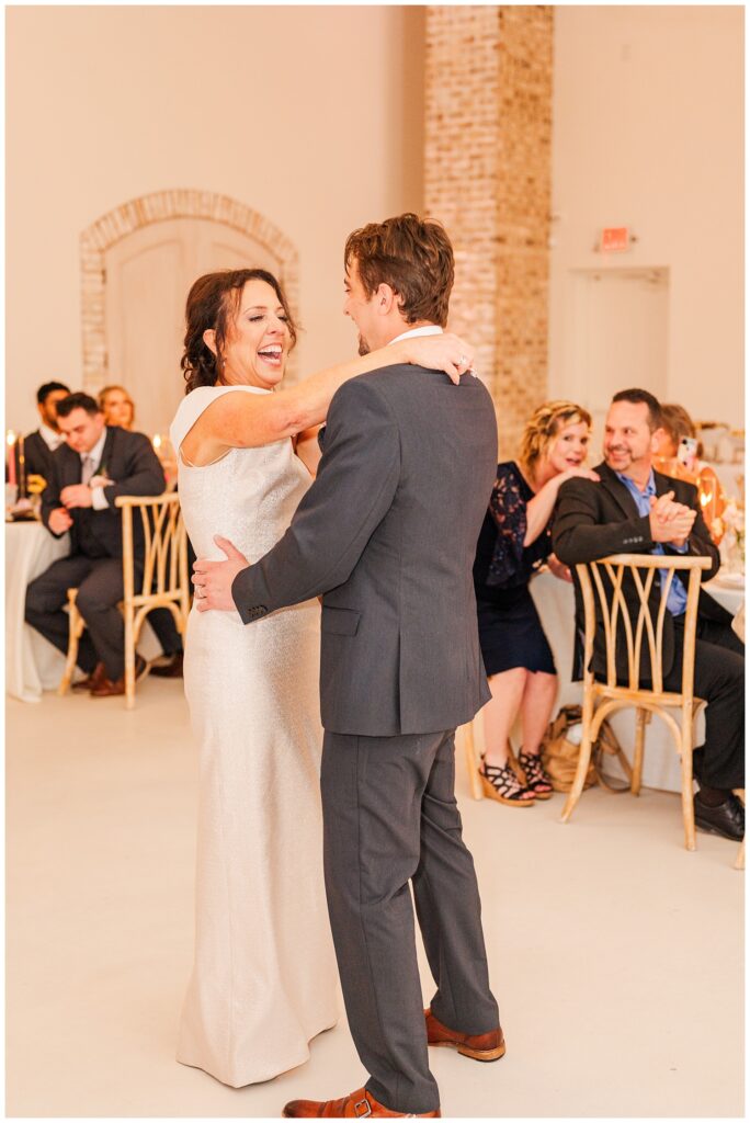 groom's mom laughing during her dance with the groom at Wilmington wedding reception