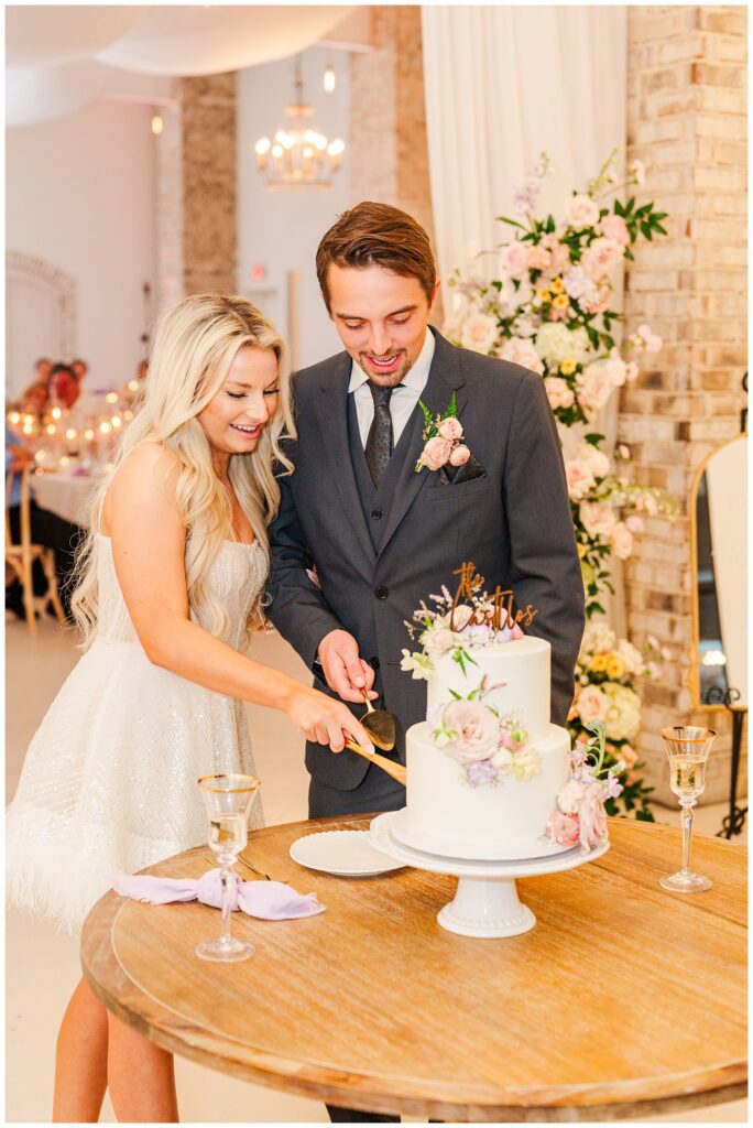 groom and bride cutting the cake at Wrightsville Manor wedding venue