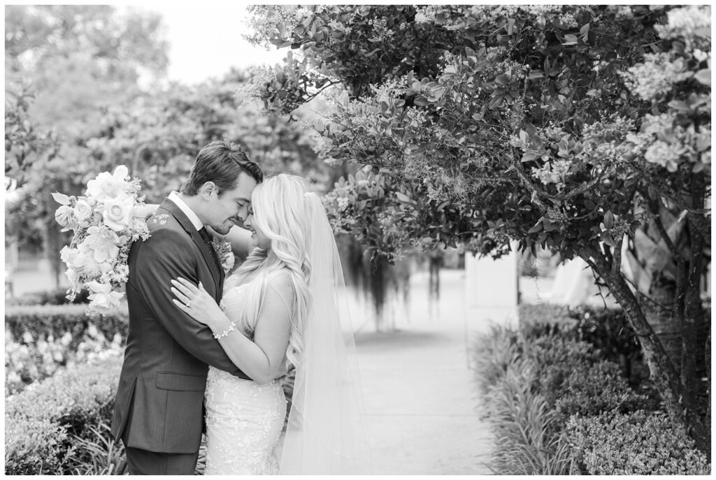 bride holding bouquet behind the groom's neck for couples portraits