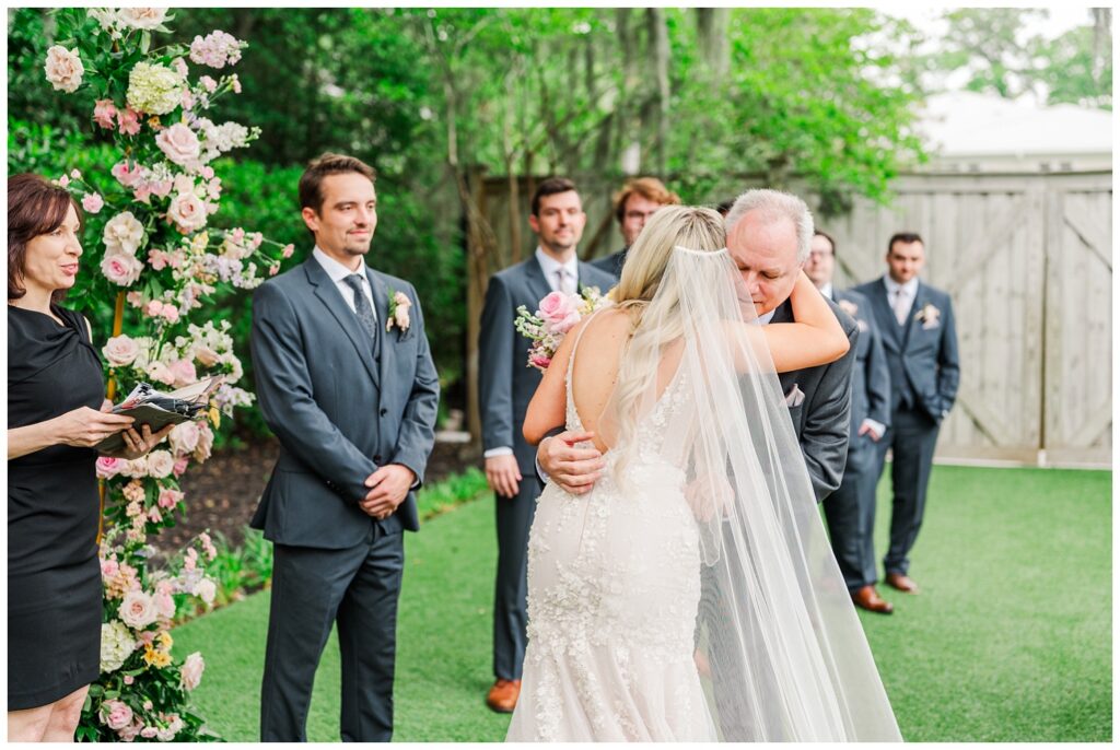 bride's dad giving her away down the aisle at Wilmington wedding ceremony