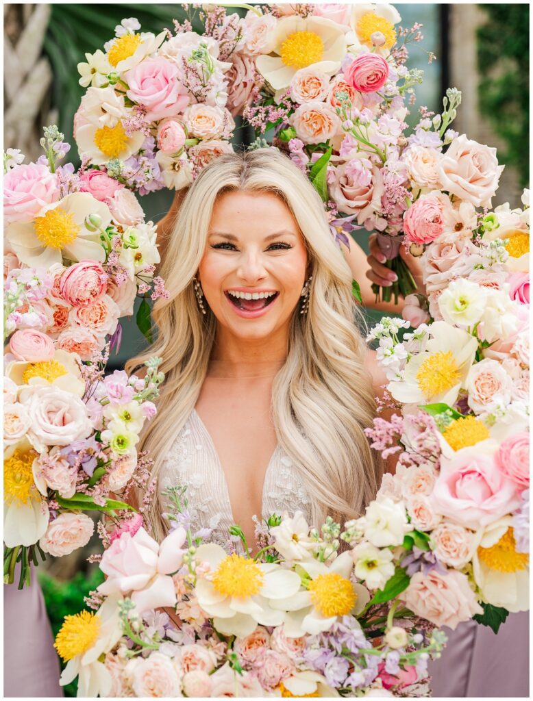 bridesmaids framing the bride's face with their bouquets in Wilmington