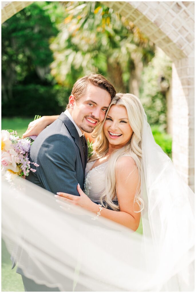 veil wrapped in front of the bride and groom at spring wedding in Wilmington