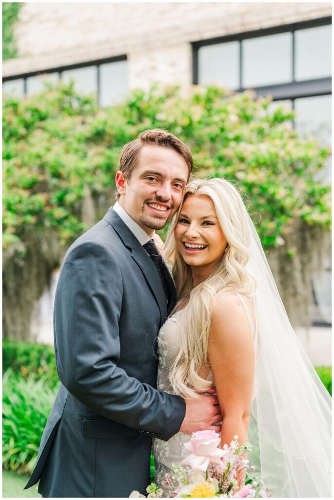 groom wrapping his hands around the bride's waist for couples portraits 