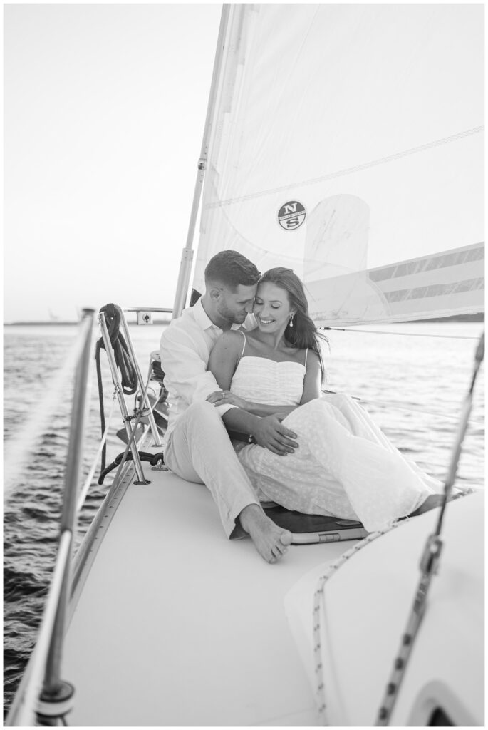 engaged couple sitting together on a boat in Carolina Beach