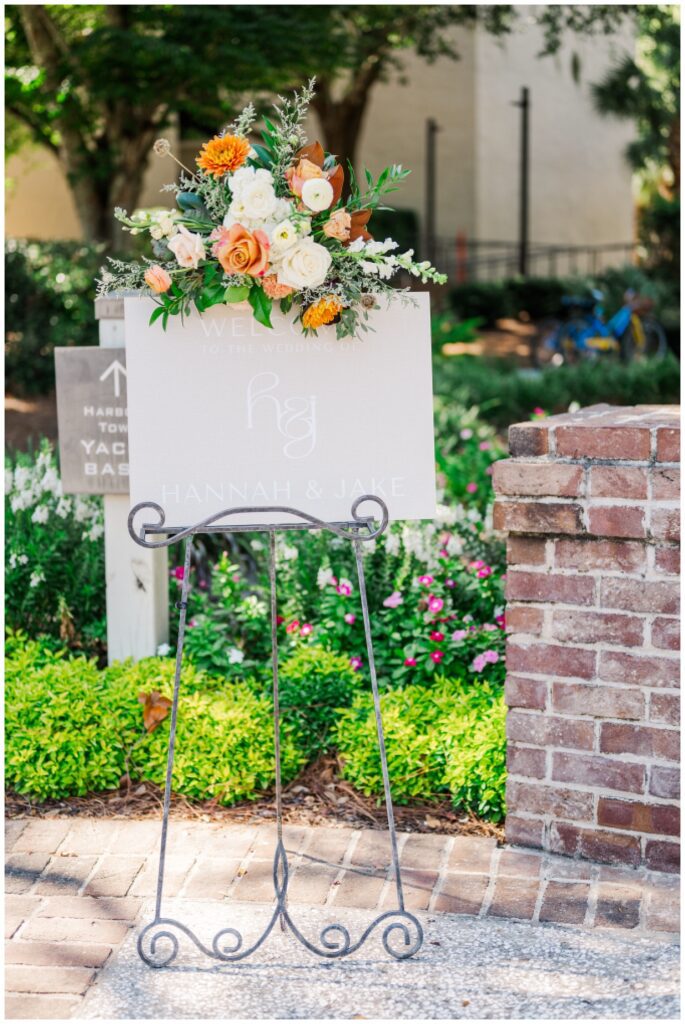 welcome sign adorned with flowers on top and sitting in an easel at Sea Pines Resort