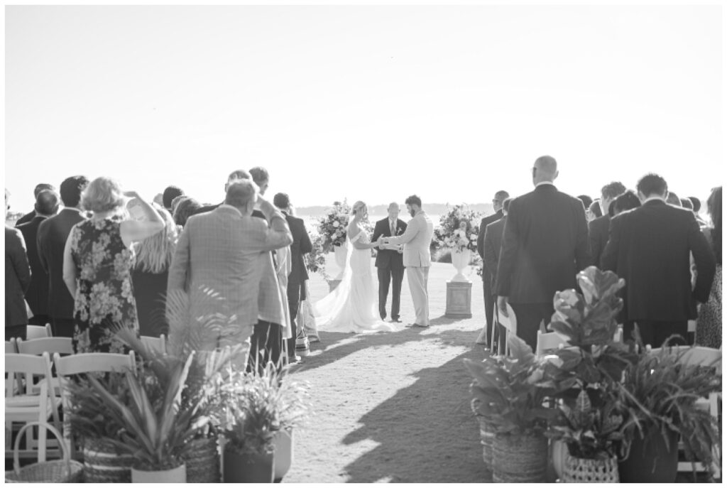 wedding couple holding hands during ceremony outside at Sea Pines Resort