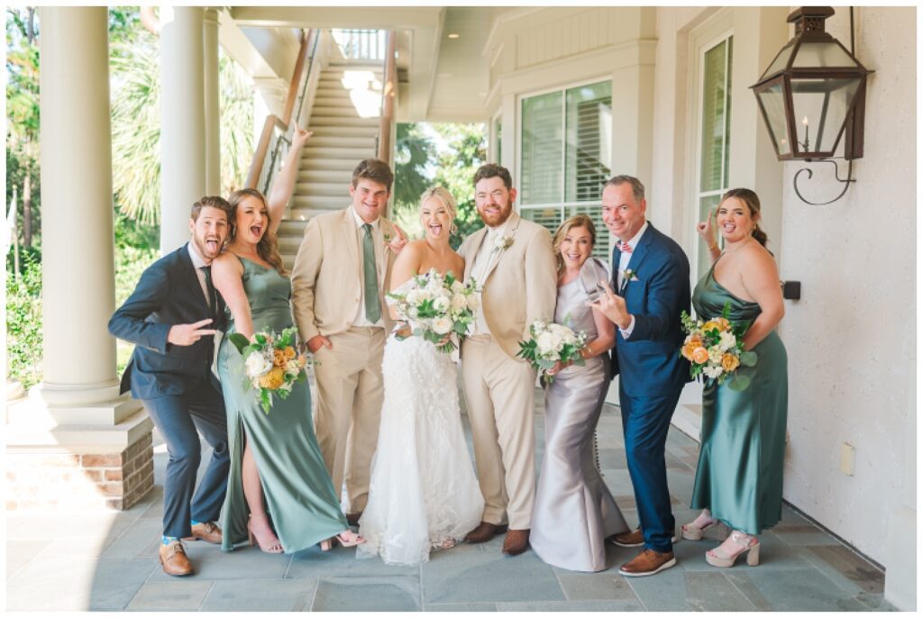 family portraits with groom's family under the balcony at Sea Pines Resort wedding venue