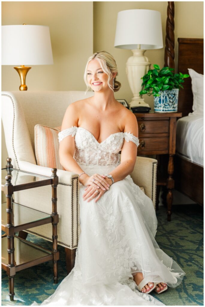 bride sitting in a chair in the hotel room after getting ready for Hilton Head wedding