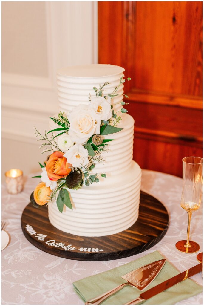 three tiered wedding cake adorned with flowers Sea Pines Resort reception