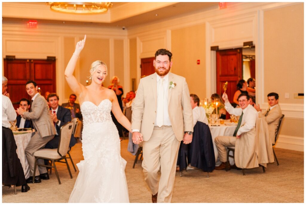 wedding couple walking in to their fall reception at Hilton Head venue