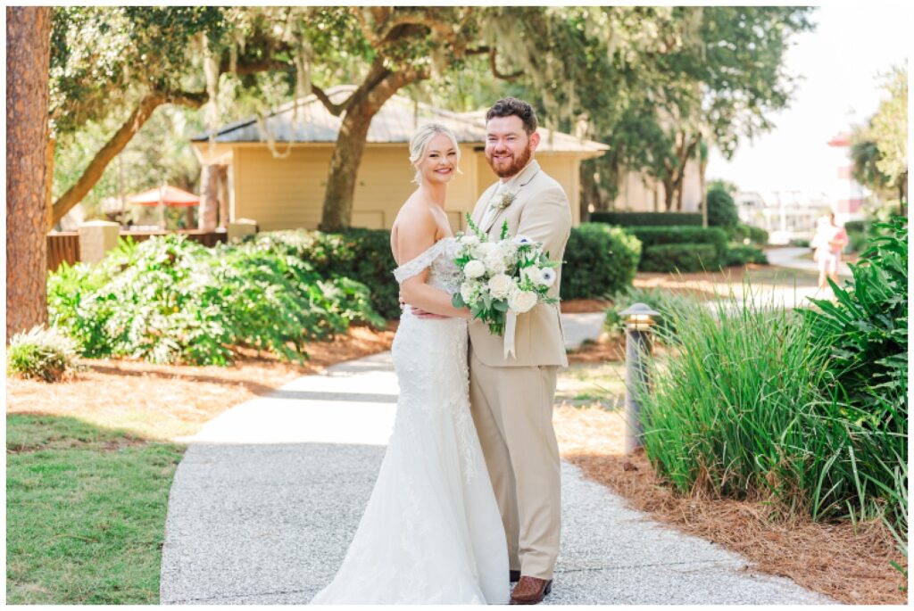 bride and groom posing on the sidewalk at Hilton Head wedding venue