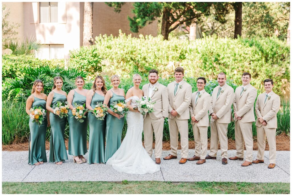 full wedding party posing on the sidewalk at Sea Pines Resort venue