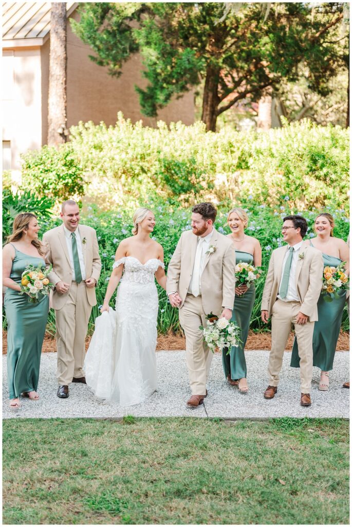 full wedding party walking on the sidewalk at Sea Pines Resort in Hilton Head