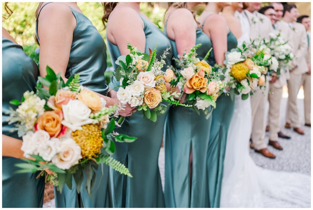 close up detail of bridesmaids' bouquets while posing for portraits 