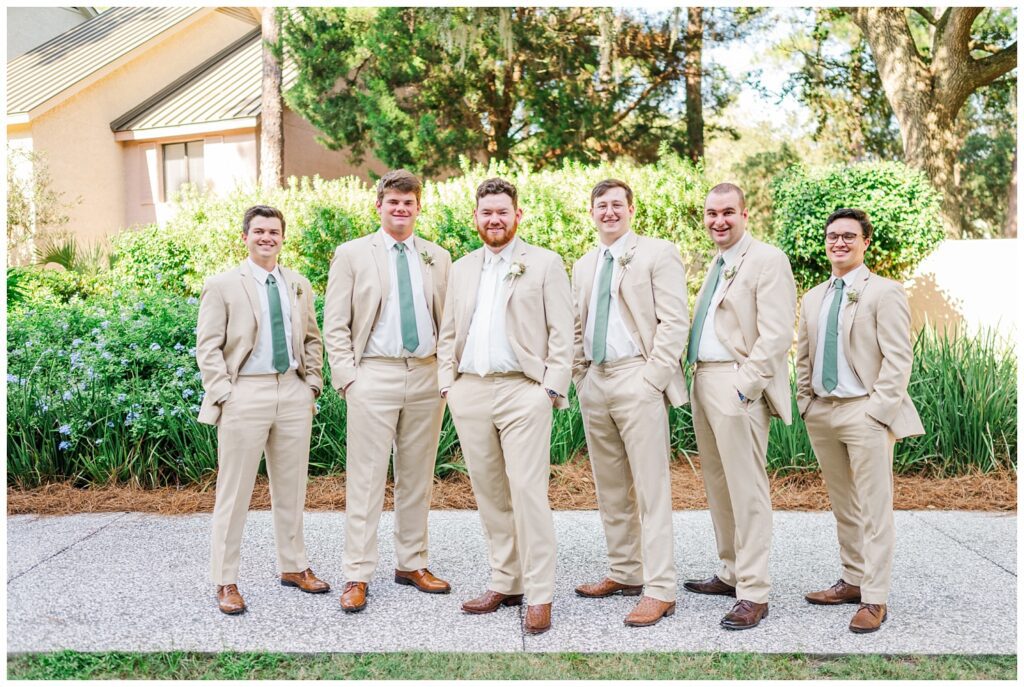 groomsmen posing on the sidewalk at fall wedding at Sea Pines Resort