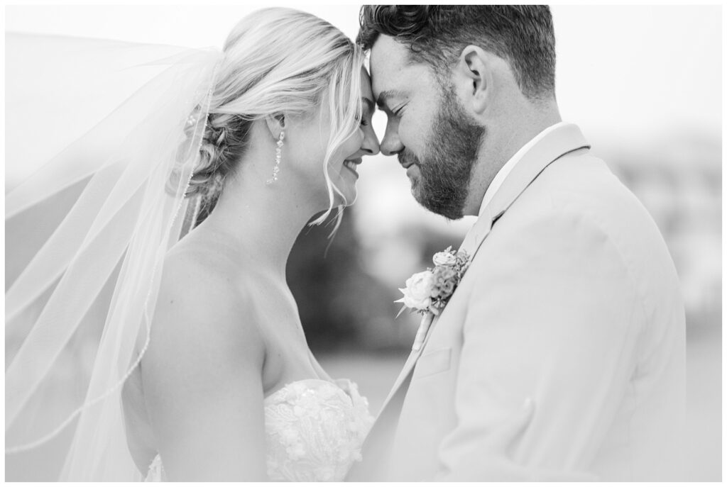 bride and groom touching foreheads during sunset portraits at Hilton Head wedding