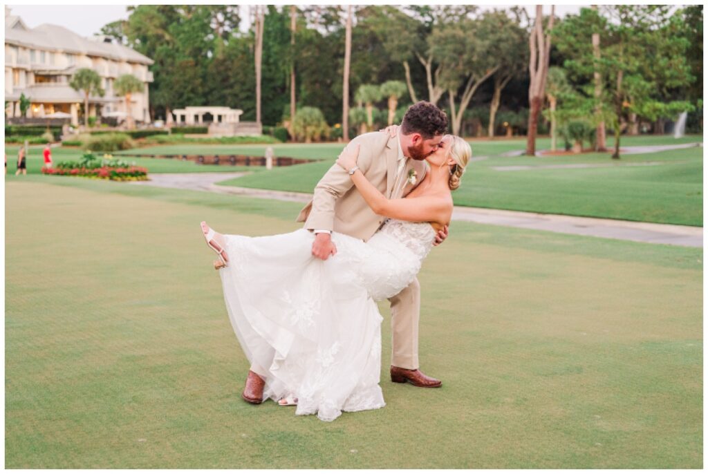 groom dips back the bride at sunset on the golf course in Hilton Head