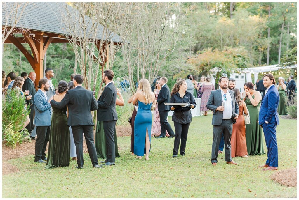 cocktail hour with guests mingling outside at Malachi Meadows venue