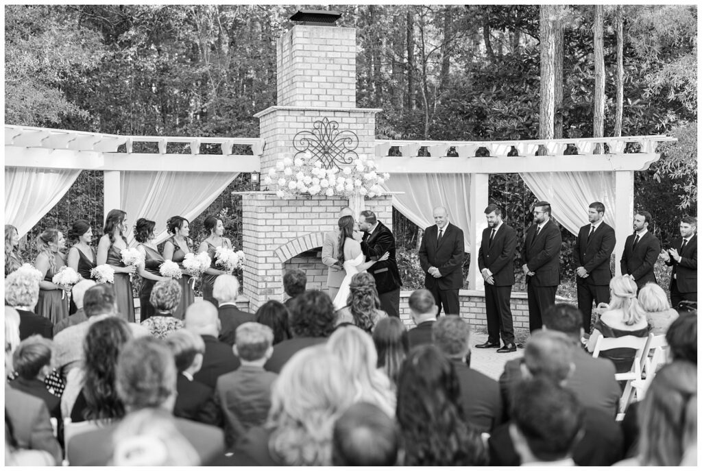 bride and groom kiss at the end of ceremony at Malachi Meadows venue