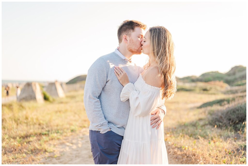 couple kissing on the grass at Fort Fisher Kure Beach, NC