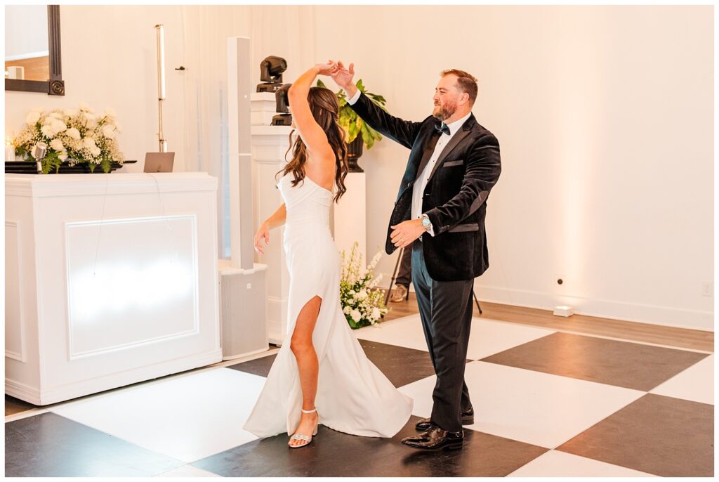 groom twirls the bride on the dance floor at Malachi Meadows wedding reception