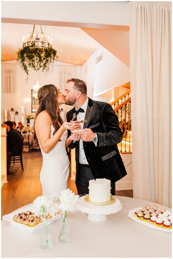 bride and groom kissing after cutting their wedding cake at reception in Currie, NC