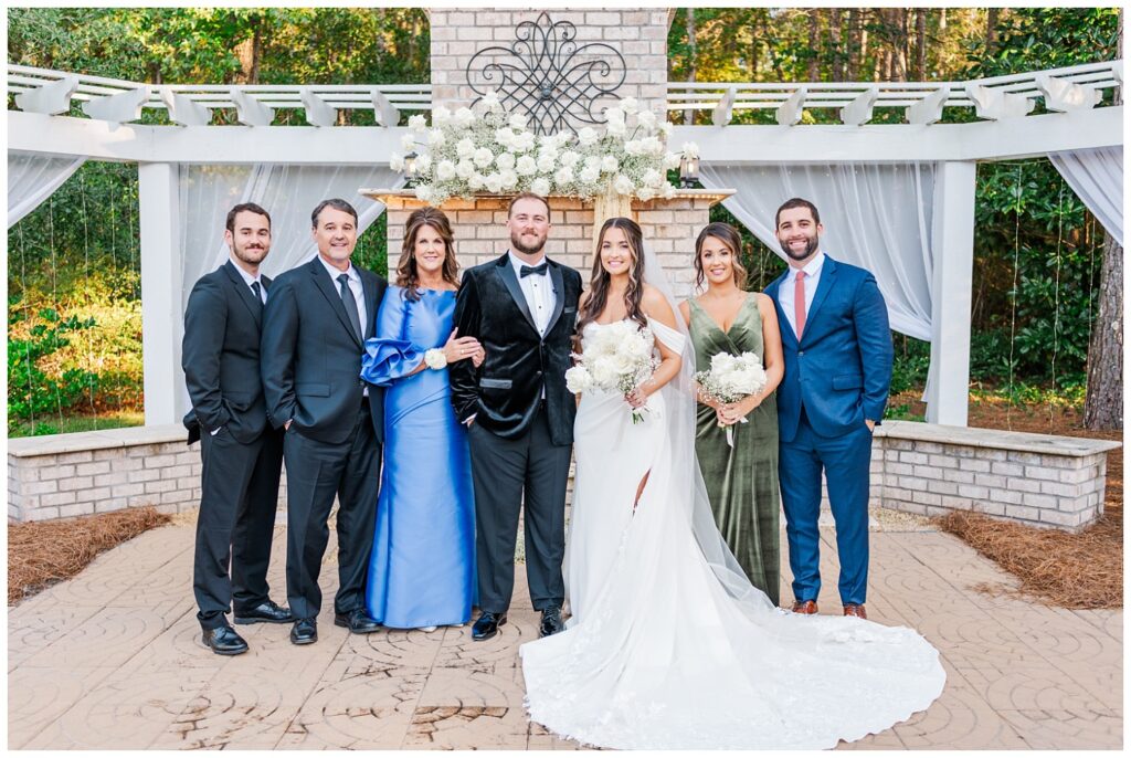 family portraits in front of the outdoor ceremony site at Malachi Meadows 