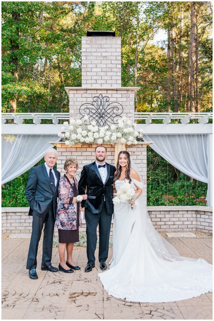 family portraits with grandparents in front of the outdoor ceremony site at Malachi Meadows 