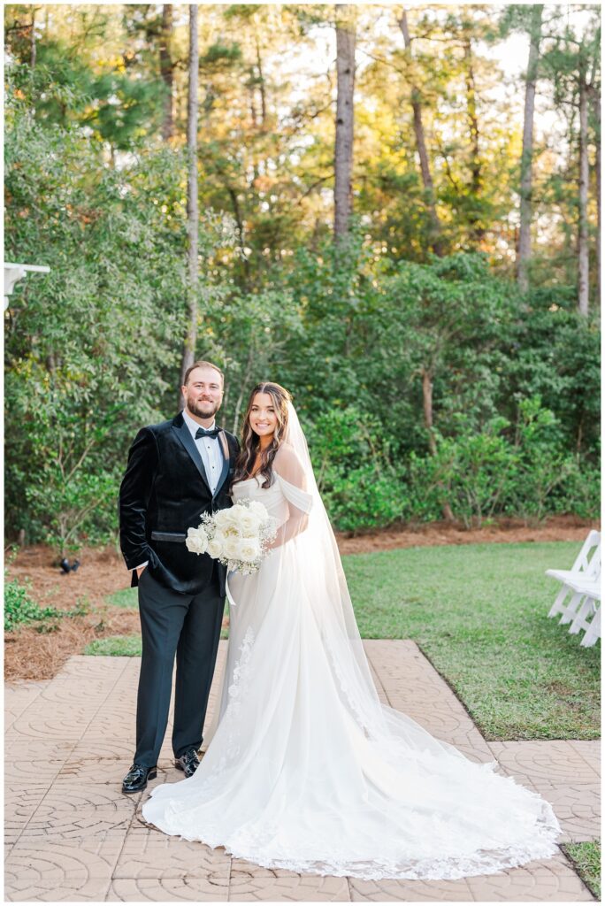 bride and groom posing next to each other at golden hour after ceremony