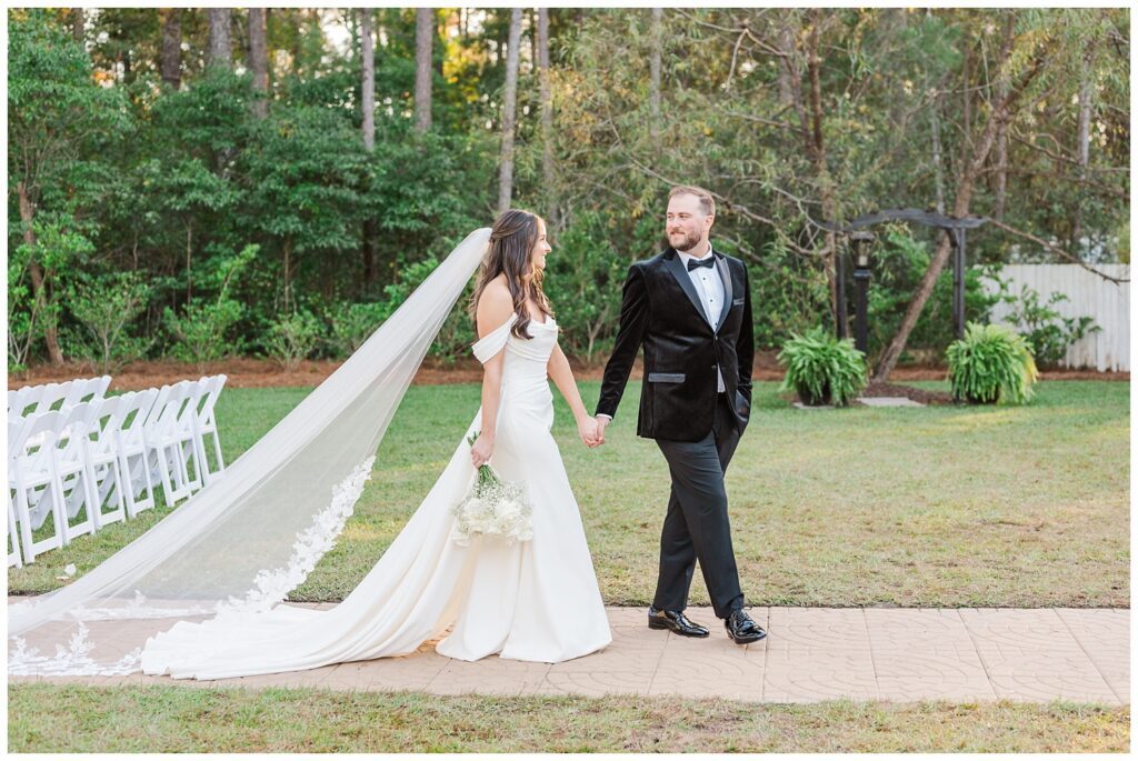 wedding couple holding hands and walking along the sidewalk after the ceremony