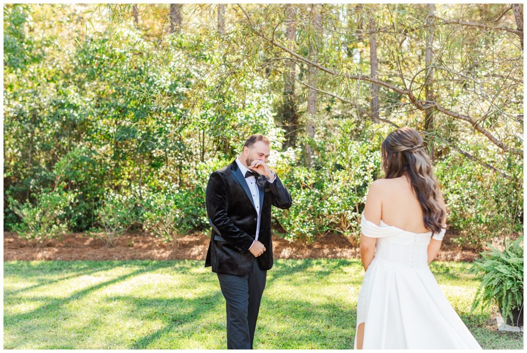 groom crying during first look outside on the grass at Malachi Meadows