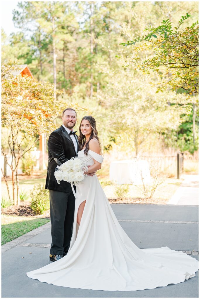 wedding couple holding each other on the patio at NC venue before ceremony