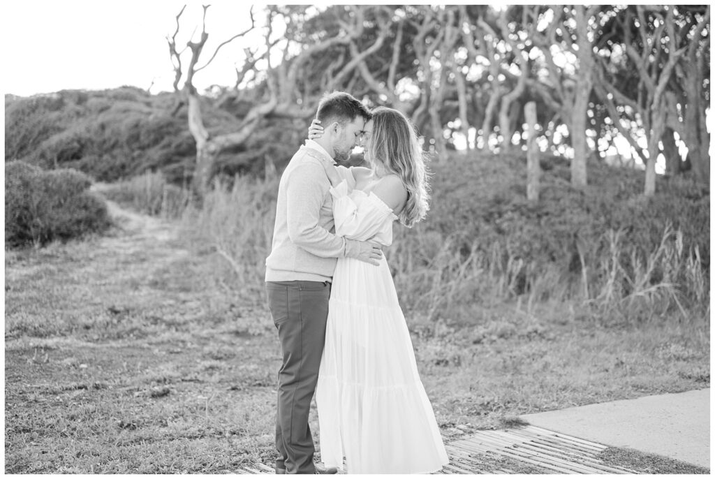 Fort Fisher engagement photographer with couple posing on a beach walk