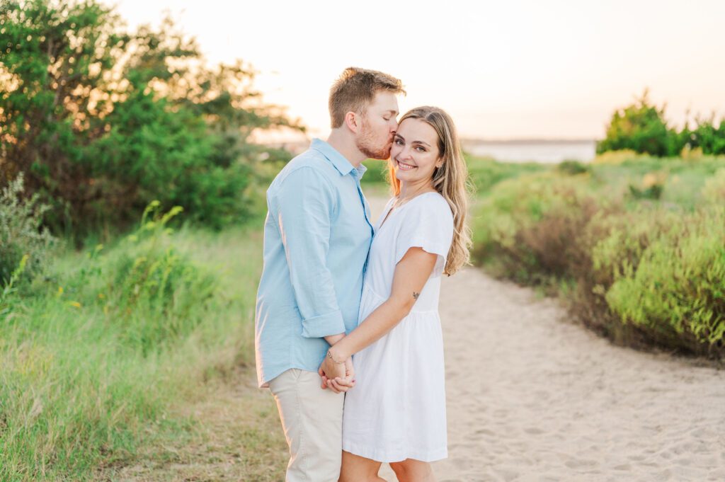 engaged couple holding hands on the beach path on Fort Fisher