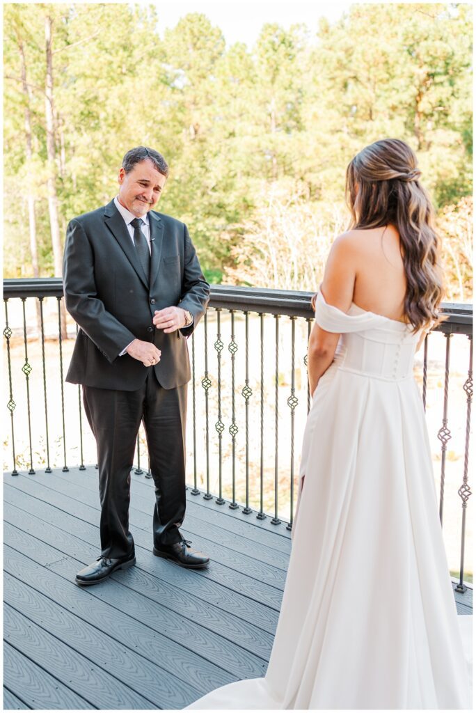 first look on a balcony between the bride and her dad at Malachi Meadows