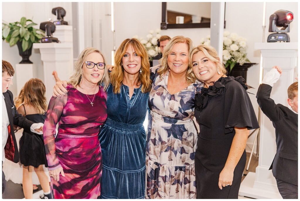 wedding guests posing for portraits during reception dancing at Malachi Meadows