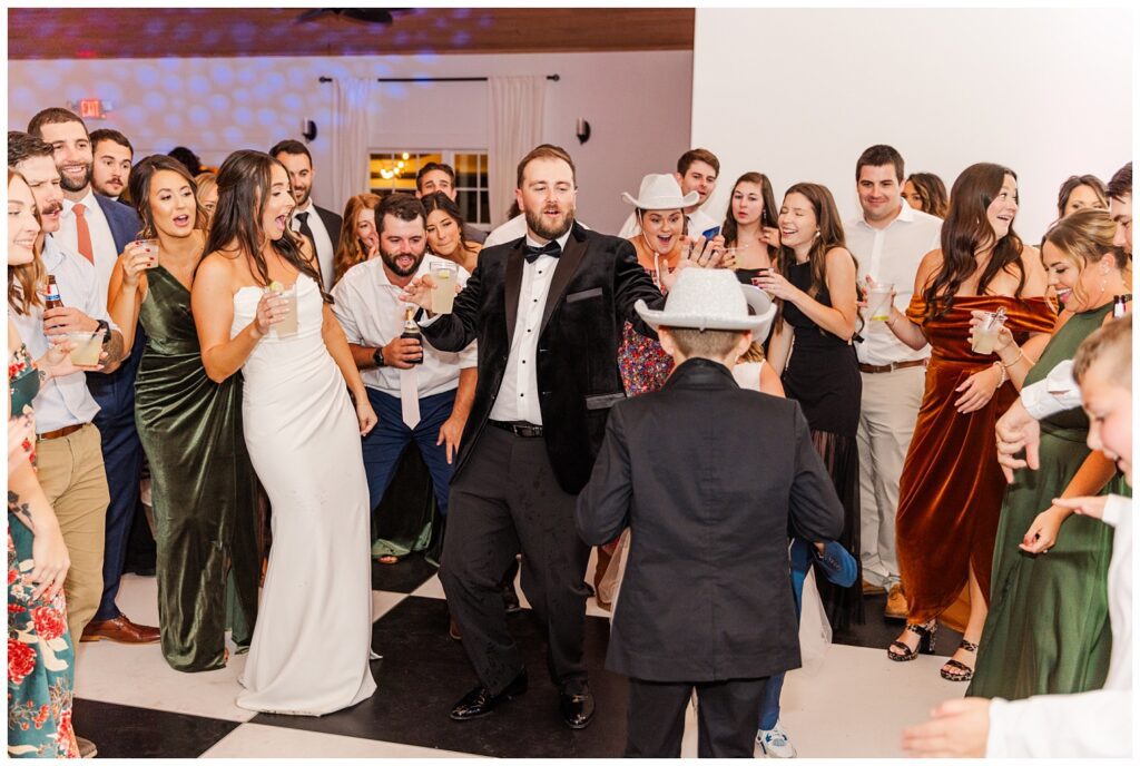 wedding guests drinking and dancing at fall reception in Currie, NC