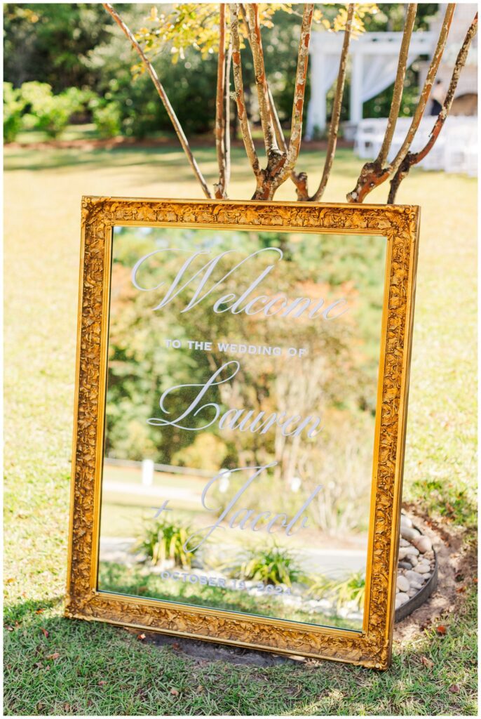 gold mirror welcome signage for outdoor ceremony at Malachi Meadows 