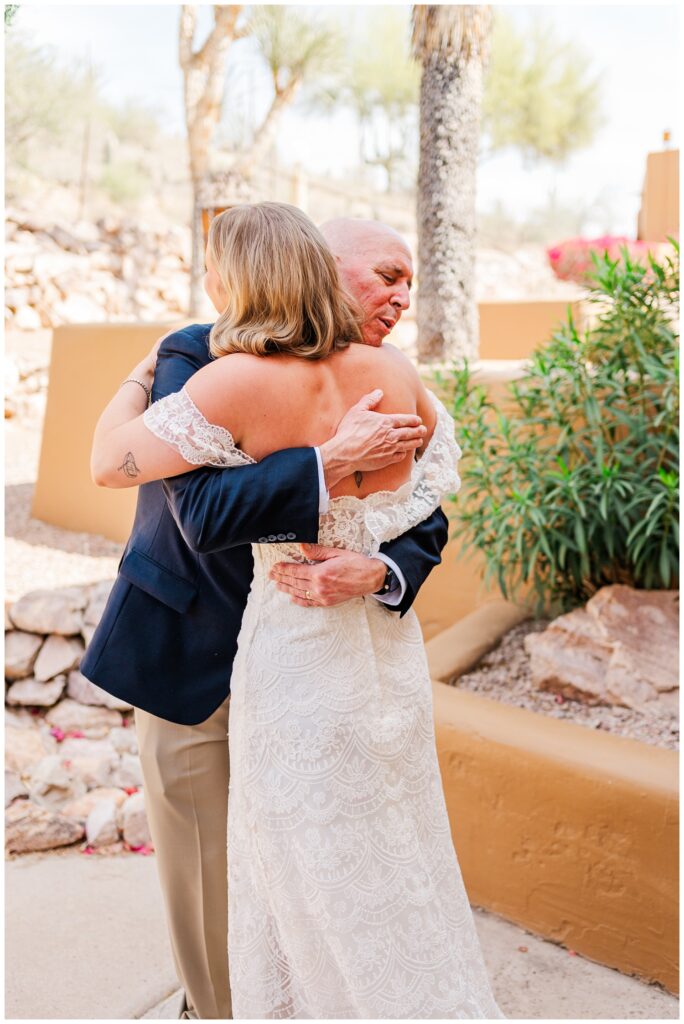 bride having a first look with her dad outside before the ceremony in Arizona