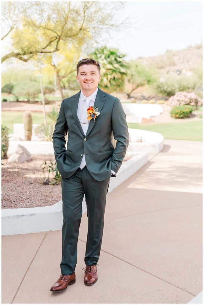 groom posing with his hands in his pocketse before the first look outside at Gold Canyon, AZ venue