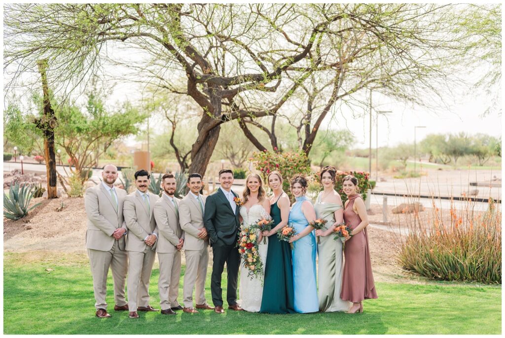 full wedding party posing together in front of a large tree in Gold Canyon, AZ