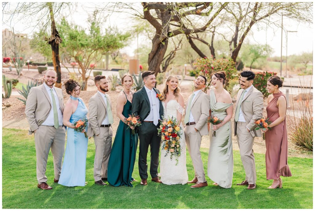 bride and groom laughing and smiling along the wedding party at Gold Canyon, AZ venue