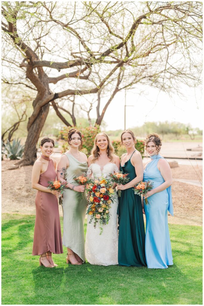 bridesmaids posing with the bride on the front lawn at Gold Canyon, AZ wedding venue