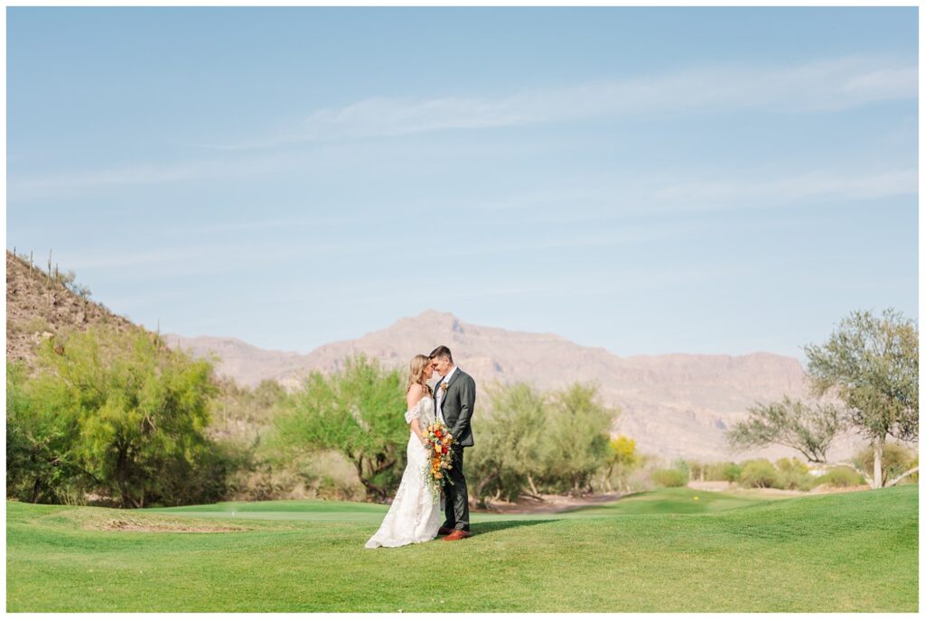 bride and groom facing each other on the golf course at Arizona wedding venue